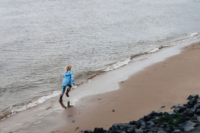 High angle view of girl running on beach