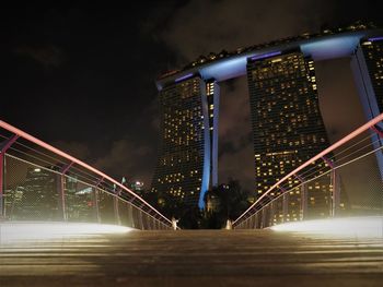 Low angle view of illuminated buildings against sky at night