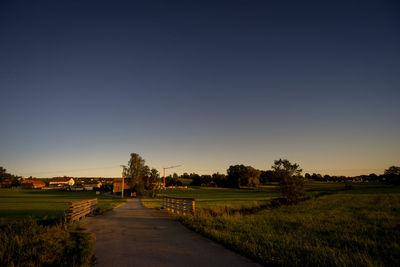 Scenic view of field against clear blue sky