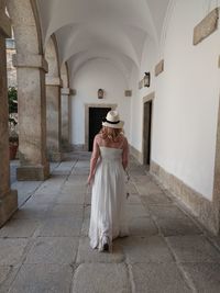 Rear view of woman walking in building