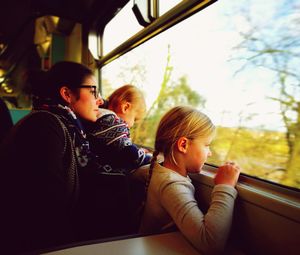 Woman with children looking from train window