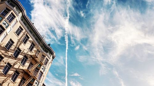 Low angle view of building against cloudy sky