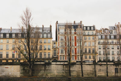 Buildings in city against clear sky