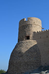 Low angle view of built structure against blue sky