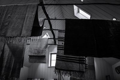 Low angle view of clothes hanging on roof of building