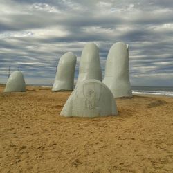 View of beach against cloudy sky