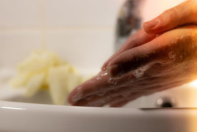 Close-up of woman preparing food at home