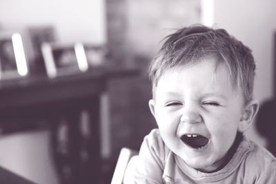 Cute baby boy yawning at home