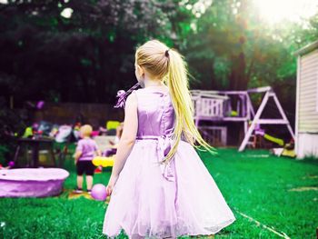 Woman standing on grass in park