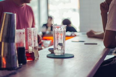 People in glass on table