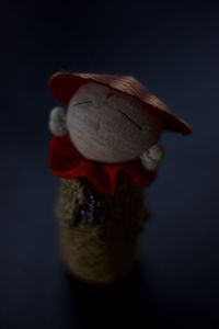 Close-up of hat with toy against gray background