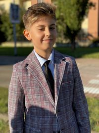 Portrait of smiling boy standing outdoors