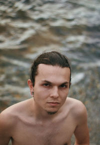 Close-up portrait of shirtless young man