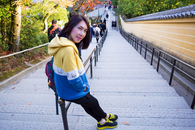 Portrait of woman on footpath