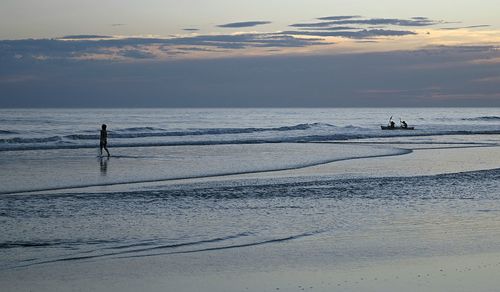 Scenic view of sea against sky at sunset