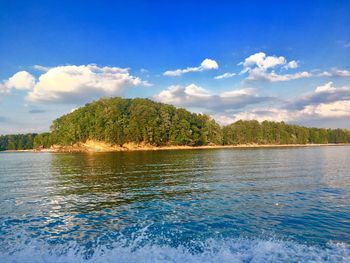 View of calm lake against cloudy sky