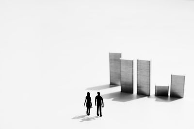 People with toy standing against white background