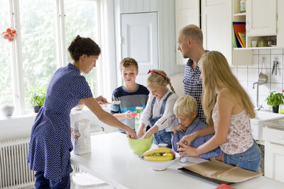 Family preparing food in kitchen