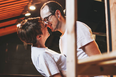 Side view of romantic couple kissing in balcony