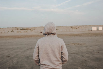 Rear view of man standing at beach