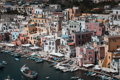 High angle view of illuminated city by sea