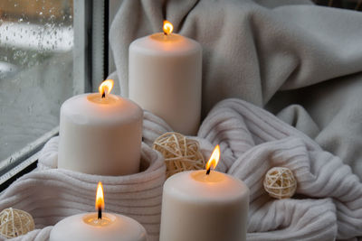 Close-up of illuminated candles on table