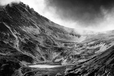 Scenic view of waterfall against sky