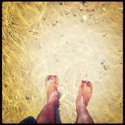 Low section of woman standing on tiled floor