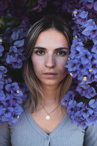 Portrait of beautiful woman with purple flower