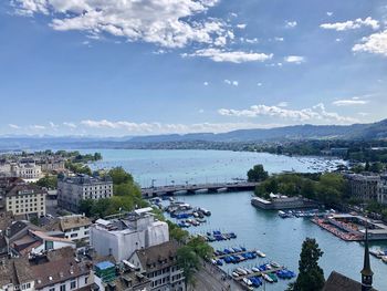 High angle view of river and townscape against sky