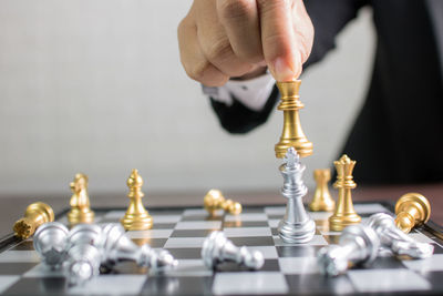 Close-up of businessman playing chess