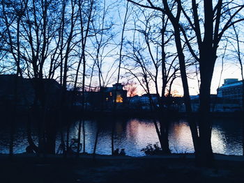 Sunset over river with buildings in background