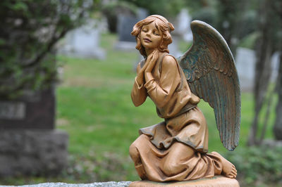 Close-up of statue in cemetery