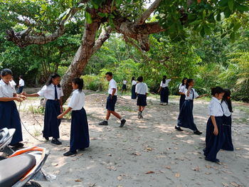 Group of people standing against plants