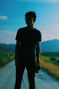 Man standing on mountain against sky