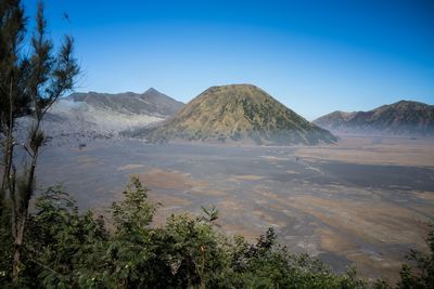 Scenic view of volcanic mountain against blue sky at mount bromo, java, indonesia. 