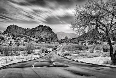 Road passing through mountains against sky