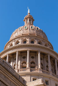 Low angle view of historical building against blue sky