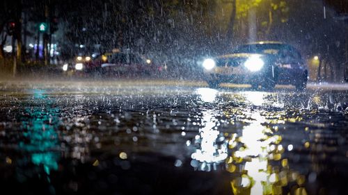 Close-up of wet car on street during rainy season