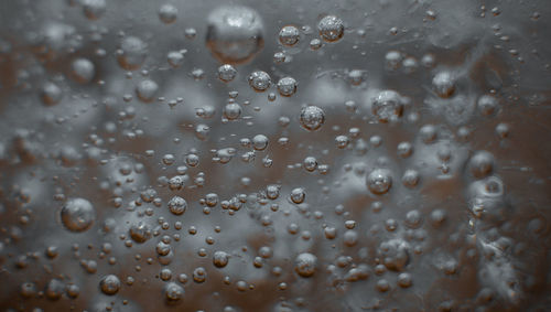 Full frame shot of raindrops on glass window