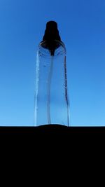 Low angle view of man standing against clear sky