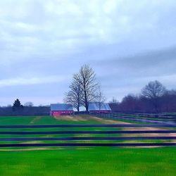 Scenic view of field against cloudy sky