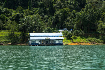 Built structure by lake in forest