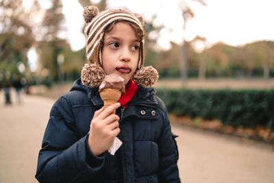 Portrait of happy boy standing on ice cream