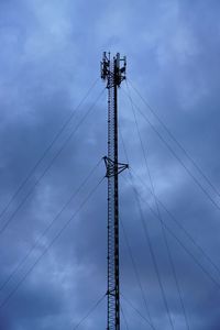 Signaling pole, low angle view of electricity pylon against blue sky