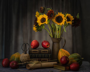 Various fruits in vase on table