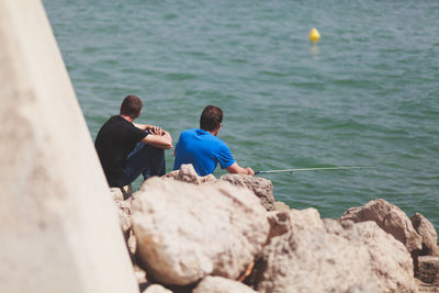 Rear view of men on beach