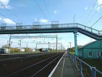 Railroad tracks against cloudy sky