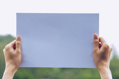 Close-up of hand holding paper