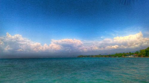 Scenic view of sea against cloudy sky